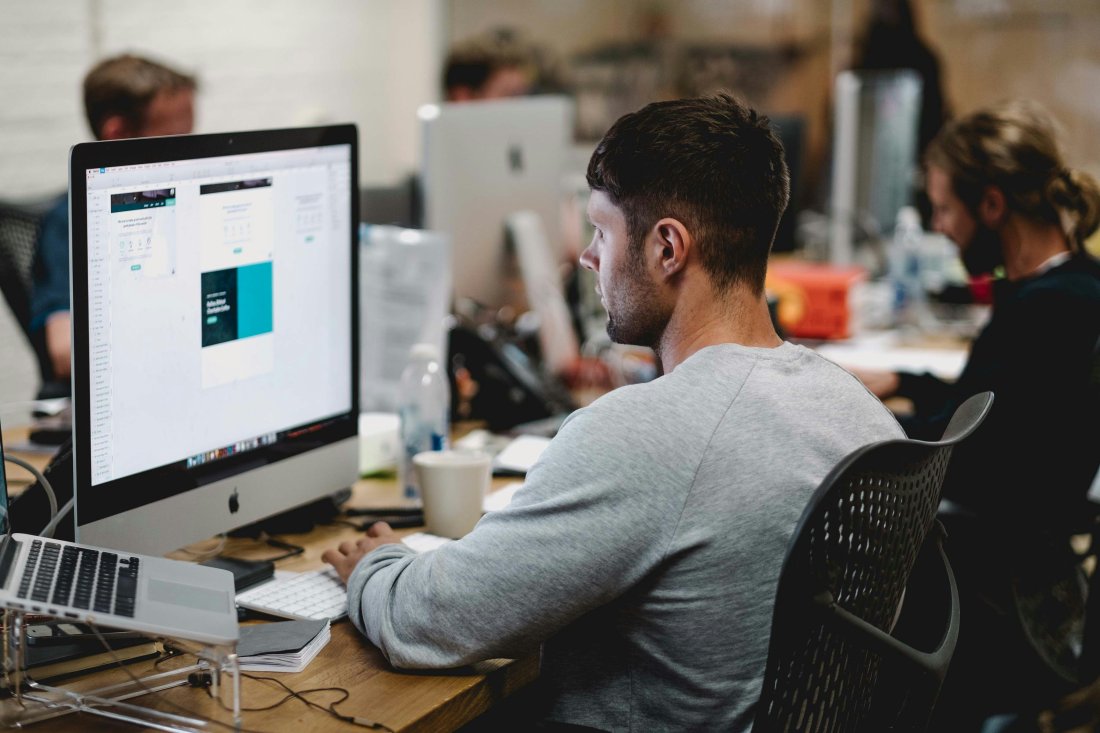 Marketers working at their desks in a busy office